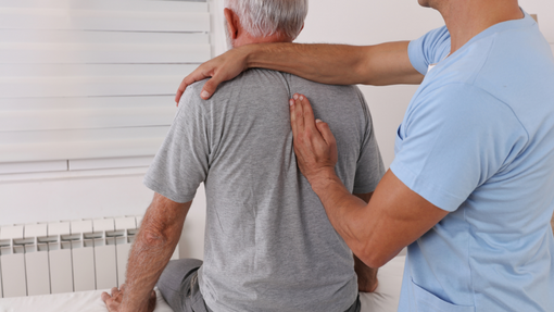 Man receiving treatment from chiropractor for neck pain.