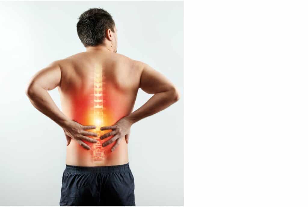 Man holding his back emphasizing spinal pain